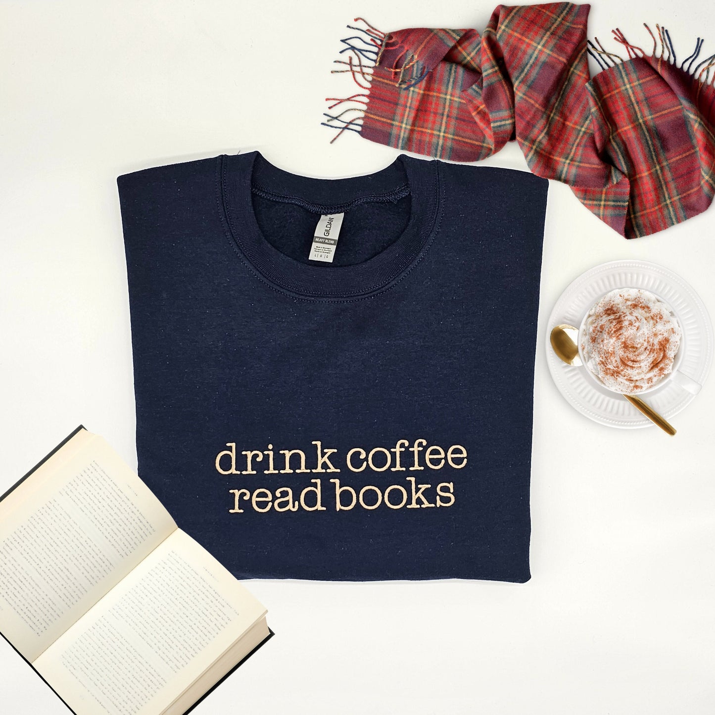 Navy blue sweater with "drink coffee, read books" embroidered on the front in fawn color thread. Book Lover Sweater