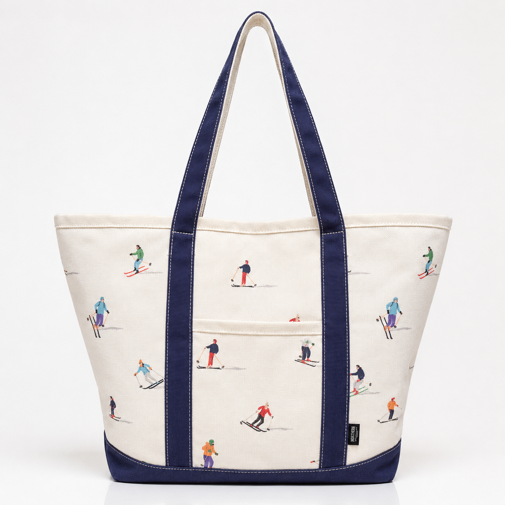 White canvas ski tote bag with navy handles and colorful skier print
