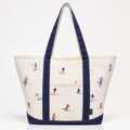 White canvas ski tote bag with navy handles and colorful skier print