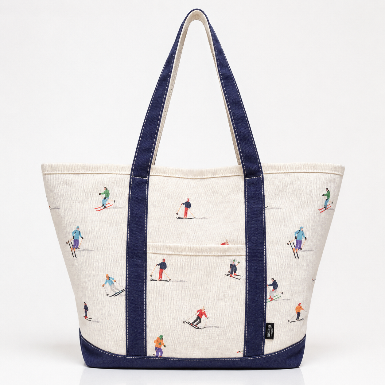 White canvas ski tote bag with navy handles and colorful skier print