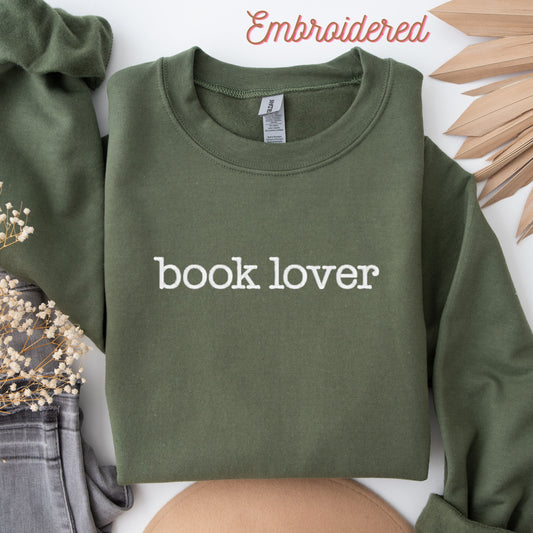 Military green fleece lined sweater embroidered with the words&quot;book lover&quot; on the front in white thread. (Can customize thread)