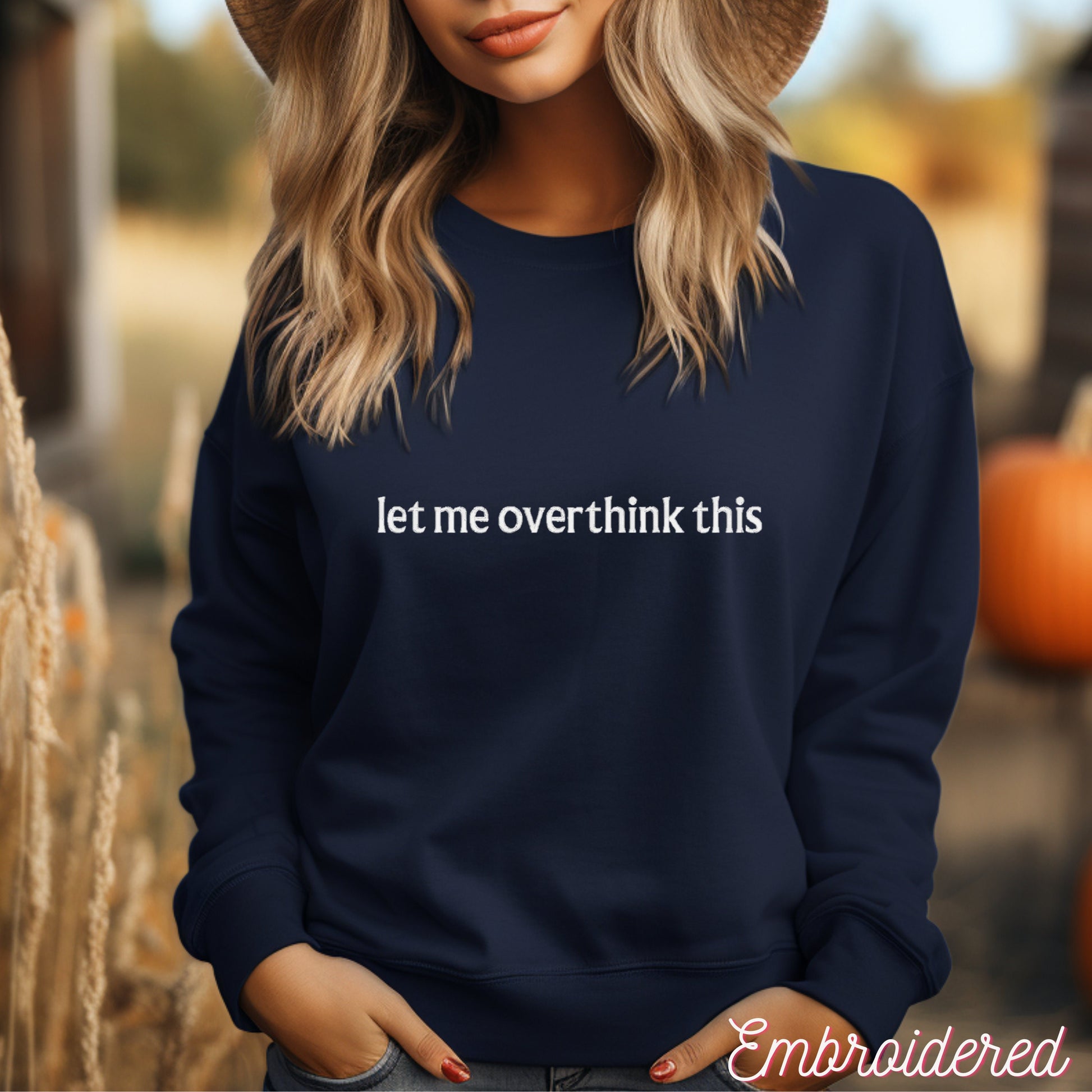 Navy blue fleece lined crewneck with the words let me overthink this embroidered on the front.