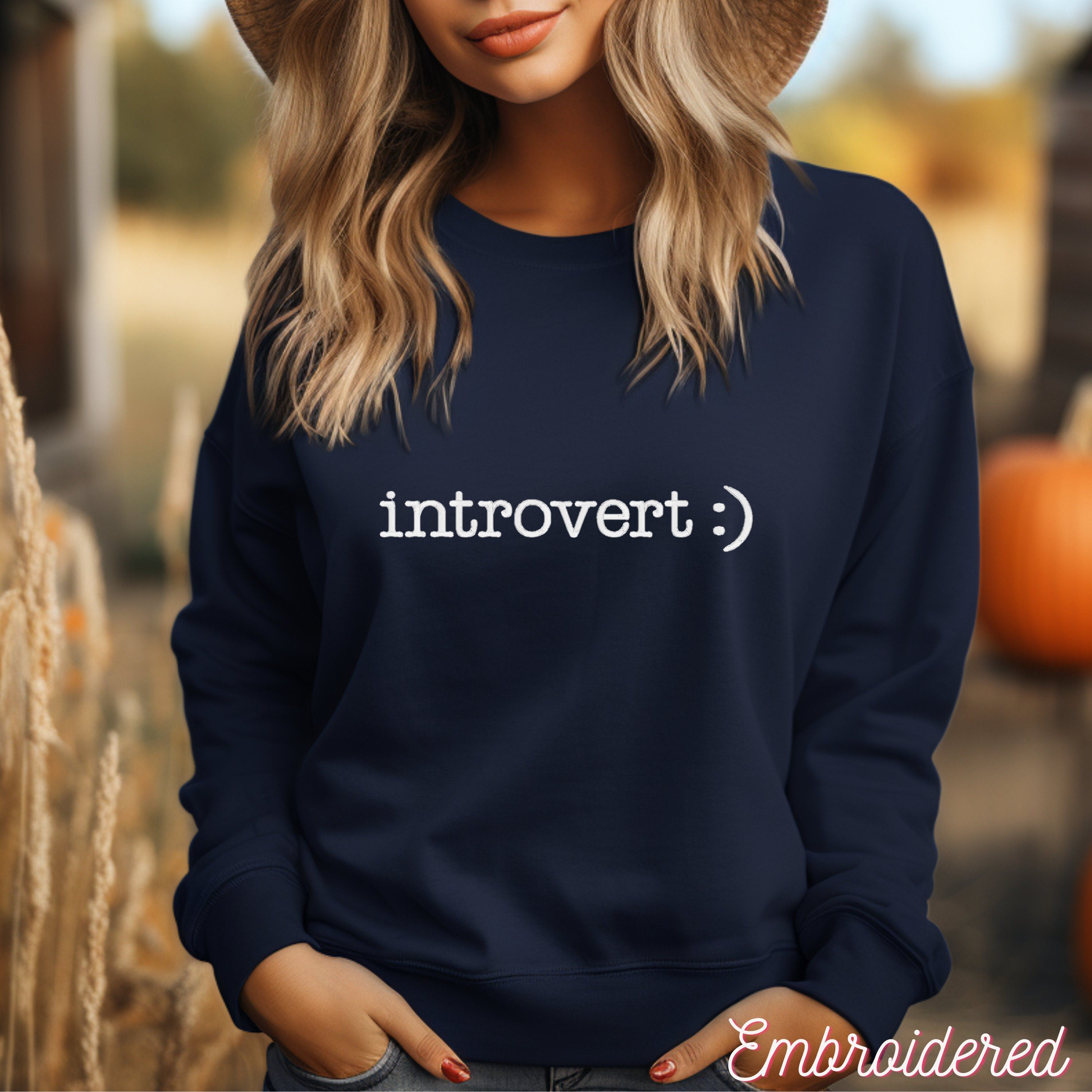 Navy crewneck fleece lined sweater with introvert :) embroidered on the front.