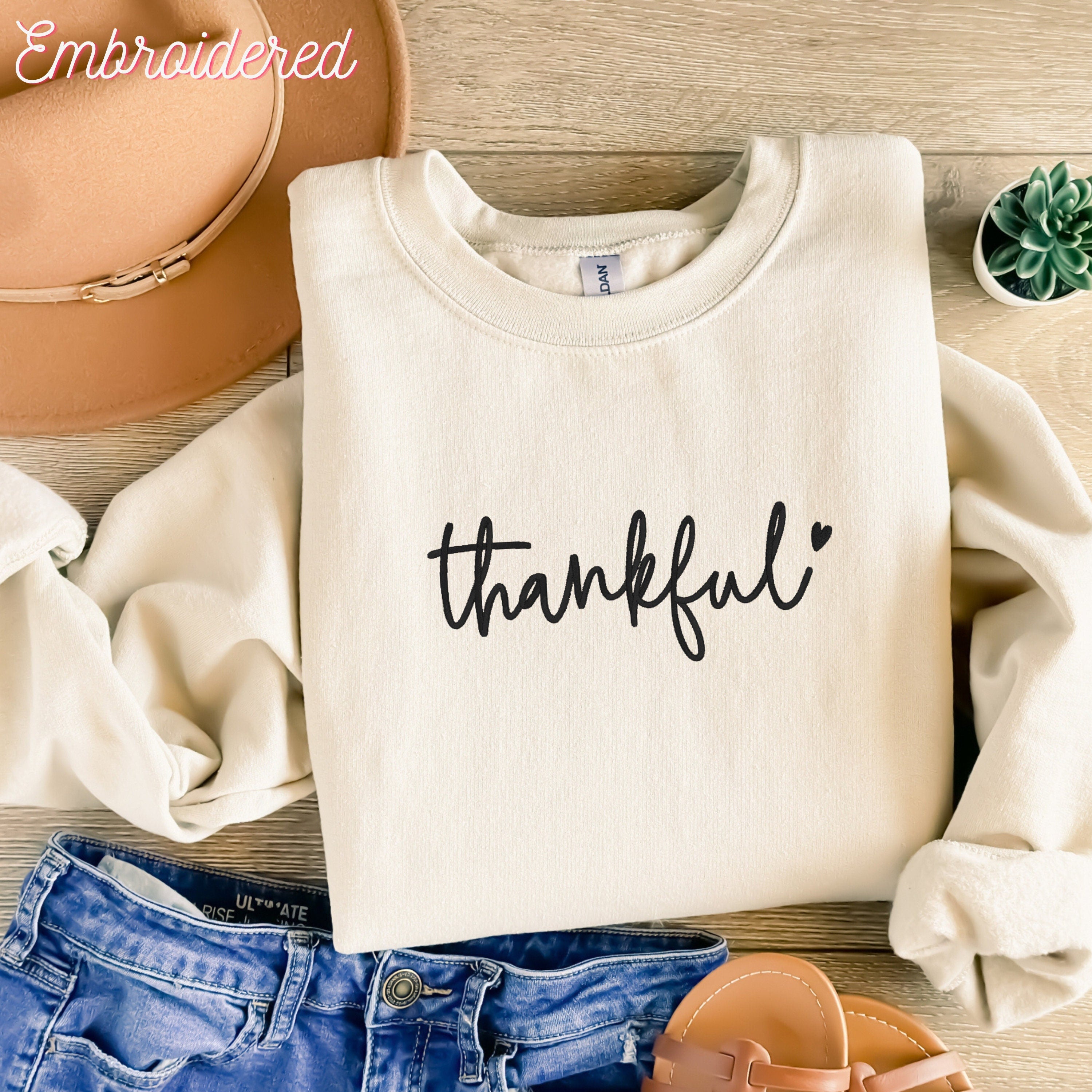 Stone crewneck fleece lined sweater with thankful embroidered on the front.