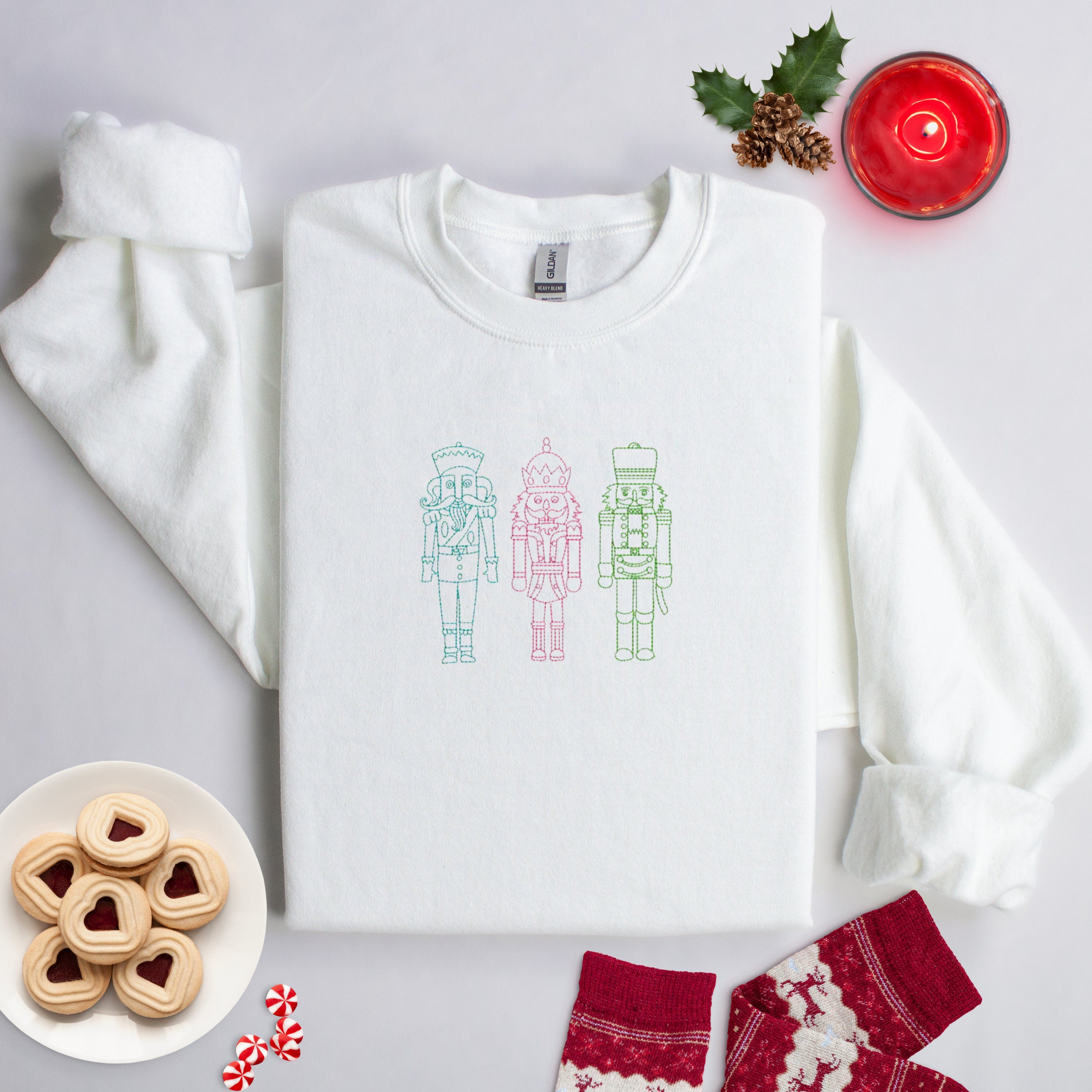 Embroidered white sweater with three nutcracker men on front. Christmas Sweater.