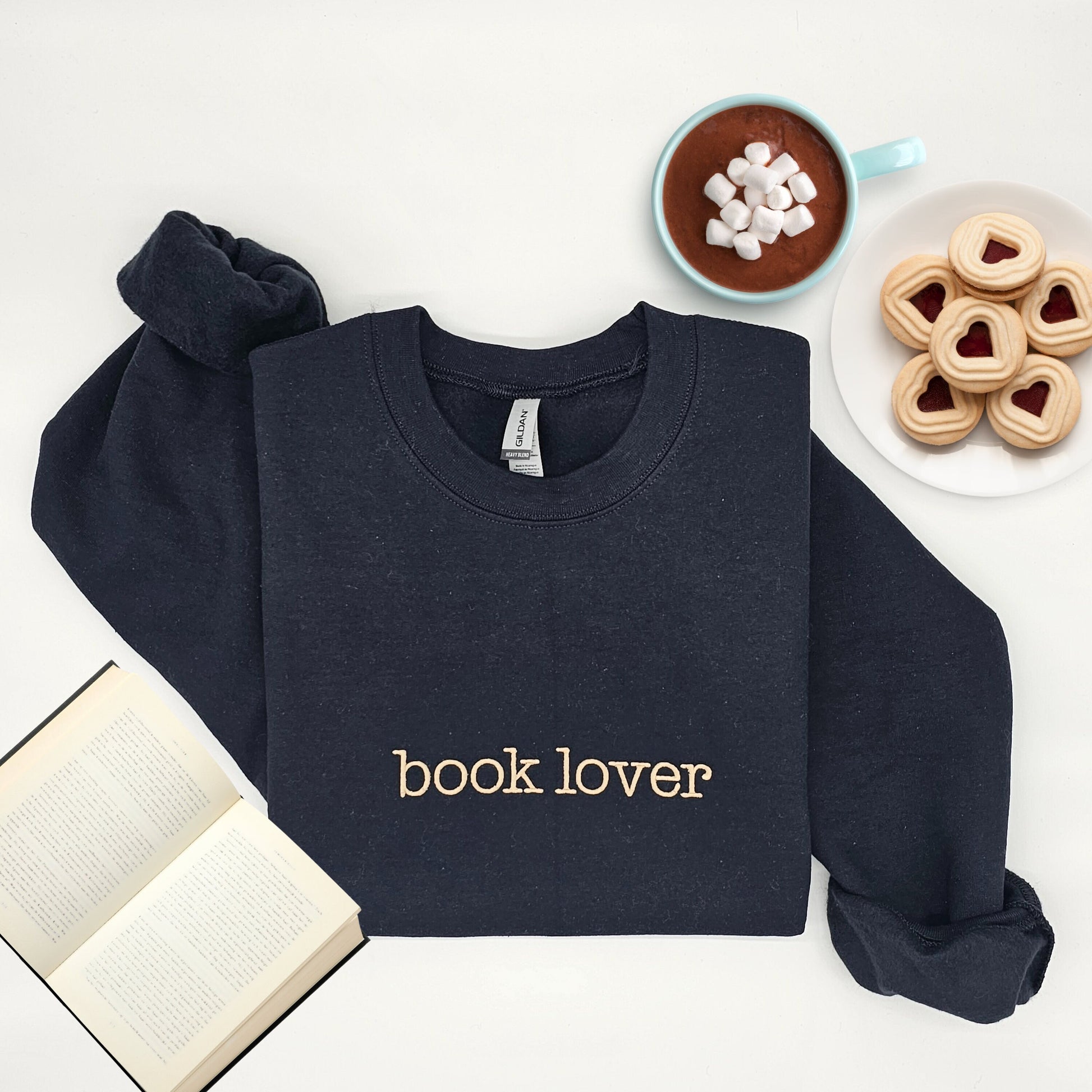 Navy Blue Crewneck sweater with the words &quot;book lover&quot; embroidered on the front in tan thread