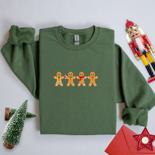 Row of gingerbread men embroidered onto a green sweatshirt.