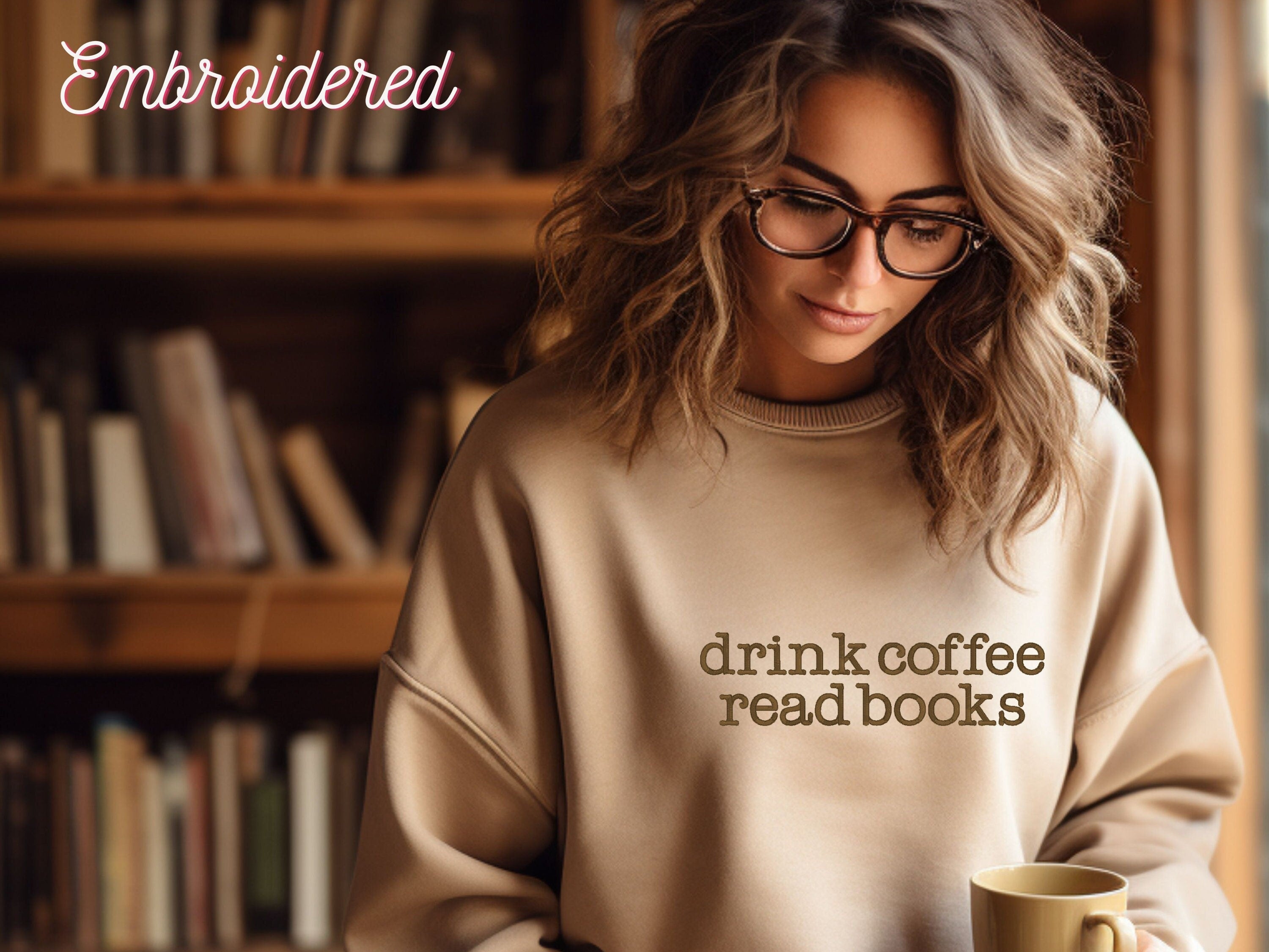 Stone crewneck cozy sweatshirt with the words drink coffee read books embroidered onto the front.