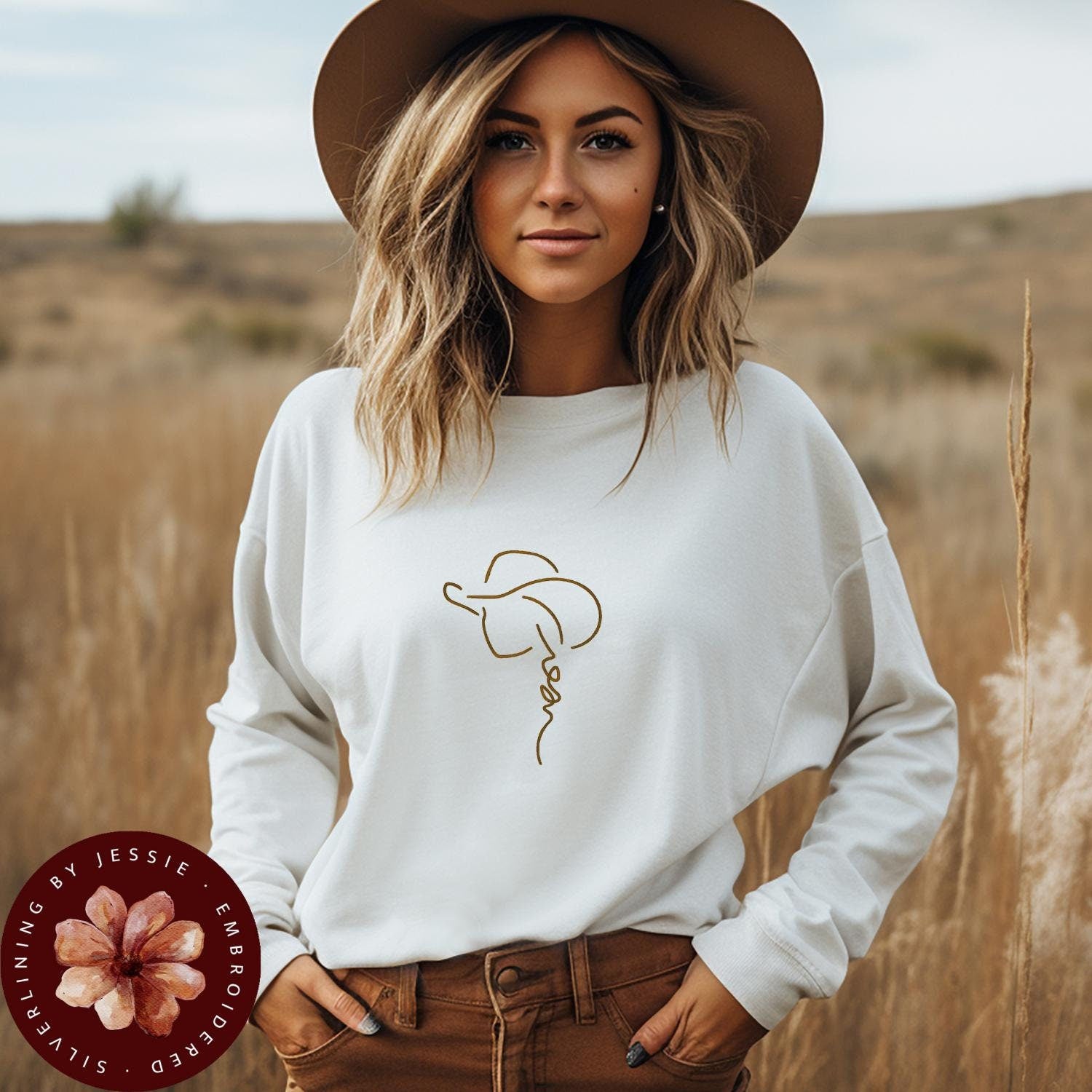 Cowgirl with hat outline embroidered onto a cozy fleece lined crewneck sweatshirt.