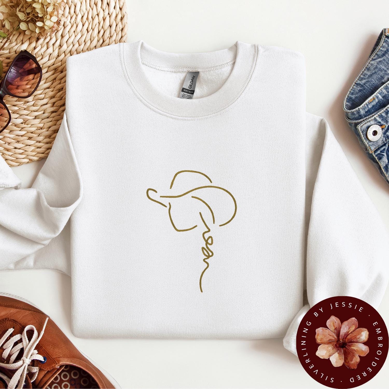 Tan Cowgirl with Hat outline stitched onto a white cozy crewneck fleece lined sweatshirt