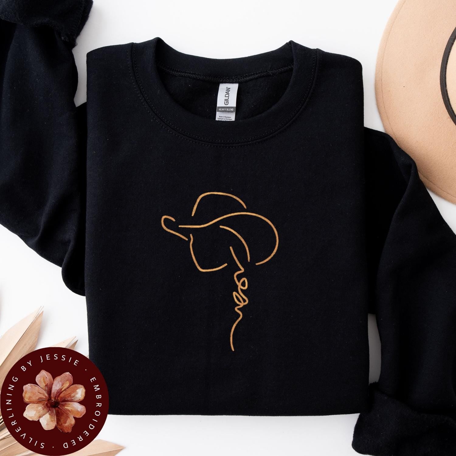 Tan Cowgirl with Hat outline stitched onto a black cozy crewneck fleece lined sweatshirt